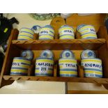 Wooden spice rack with eight pottery spice containers and lids