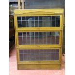 AN OAK WERNICKE STYLE SINGLE PIECE BOOKCASE with leaded glazed lift-up front doors, 114.5 cms