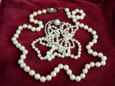 TWO VINTAGE PEARL NECKLACES including a 60 cms single strand of uniform 7mm beads with a gold