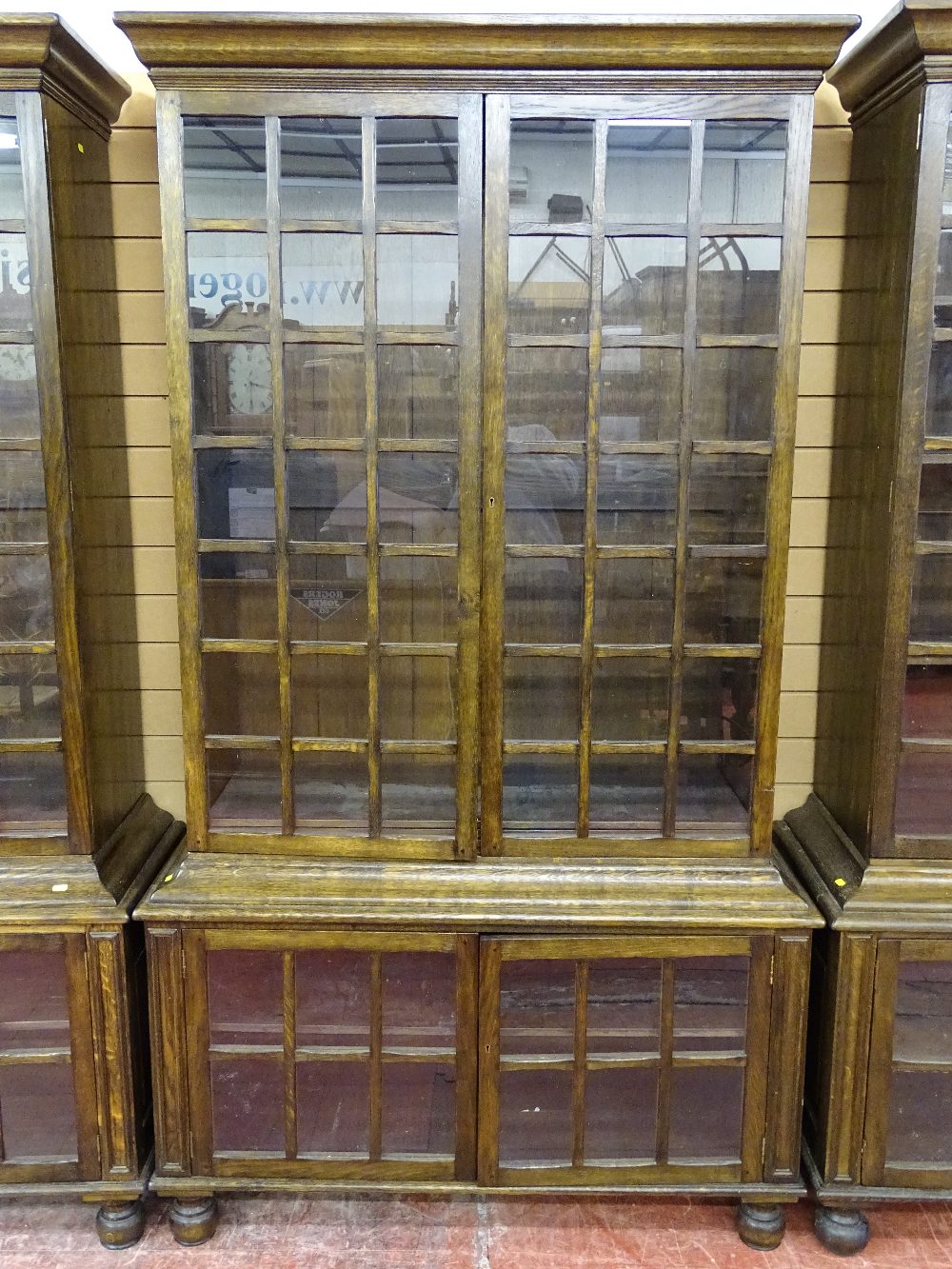 A GOOD SET OF FOUR 20th CENTURY OAK DOUBLE BOOKCASES having multi-panelled twin upper and lower - Image 4 of 6