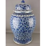 A LARGE CHINESE BLUE & WHITE TEMPLE JAR & COVER, with all over painted leaf and floral design, the
