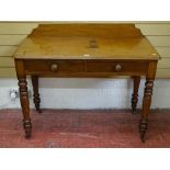 A VICTORIAN MAHOGANY TWO DRAWER SIDE TABLE with shaped railback on turned supports and brass