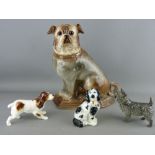 FOUR POTTERY DOG FIGURINES including a large seated pug with glass eyes, a Beswick spaniel, a Goebel