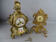 A FRENCH ROCOCO GILT METAL MANTEL CLOCK with painted porcelain dial and panel, Japy Freres bell