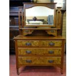 A CIRCA 1900 WALNUT MIRRORED DRESSING CHEST having two upper drawers with shelf over two short and