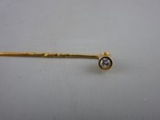 A NINE CARAT GOLD LAPEL PIN with round cut diamond, 1.2 grms
