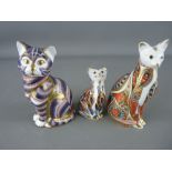 THREE ROYAL CROWN DERBY CAT PAPERWEIGHTS, numeral backstamps MMI and LXII, both gold stoppers and