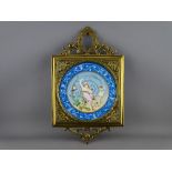 A 19th CENTURY CIRCULAR PORCELAIN HANDPAINTED PLAQUE in a gilt brass frame with leaf swag mounts, 40