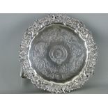 A GEORGE IV SILVER CIRCULAR THREE FOOTED TRAY, London 1825, maker Joseph Cradock, having a pierced