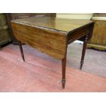 A GEORGIAN MAHOGANY TWIN FLAP PEMBROKE TABLE with single end drawer on turned supports with brass