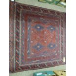 A CAZAK RUG, blue and red ground, multiple bordered with central diamond pattern, 118 x 116 cms