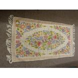 A KASHMIRI CHAIN HAND STITCH RUG, tassel ended cream ground with central floral cameo, 120 x 69 cms