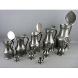 AN EXCELLENT SET OF TEN FRENCH PEWTER FLAGONS with double acorn thumbpieces, graduating from 26