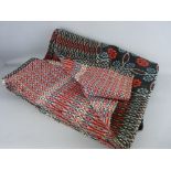 A TRADITIONAL WELSH WOOLLEN BLANKET in black and red repeating patterns, 188 x 220 cms