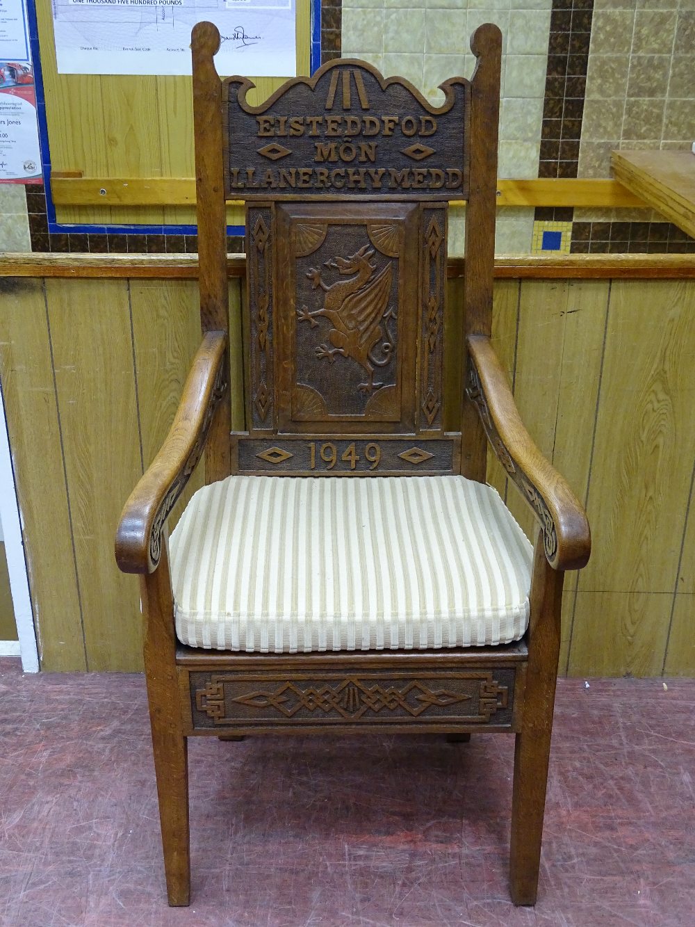 AN ANGLESEY OAK EISTEDDFOD ARMCHAIR with central dragon carved panel, the shaped upper rail