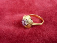 AN EIGHTEEN CARAT GOLD LEAF CLUSTER DRESS RING with seven garnets, 5 grms, size 'O'