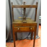AN ANTIQUE MAHOGANY BOOK PRESS, a single frieze drawer with turned wooden knobs, the whole raised on