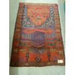 A BALUCHI PRAYER RUG, red and blue ground with architectural and floral pattern, 135 x 91 cms