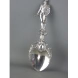 A 925 CONTINENTAL SILVER DECORATIVE SPOON with wide bowl, having leaf decoration leading to a well