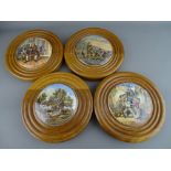 FOUR VICTORIAN OAK MOUNTED PRATTWARE POT LIDS, three titled 'The Wolf & The Lamb', 'D R Johnson', '