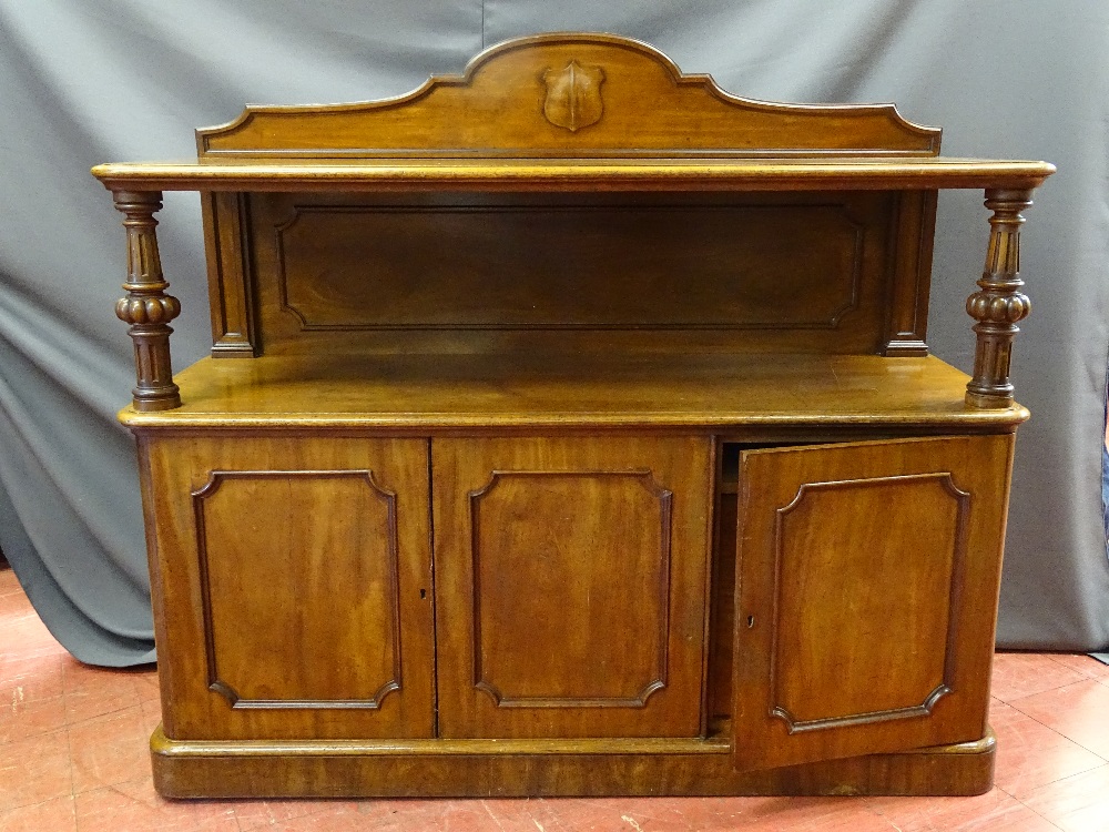 A VICTORIAN MAHOGANY SERVER with shield back rail, carved column supports and triple door lower