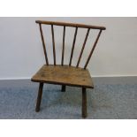 PRIMITIVE WELSH STICK CHAIR on three turned legs and with a six spindle back