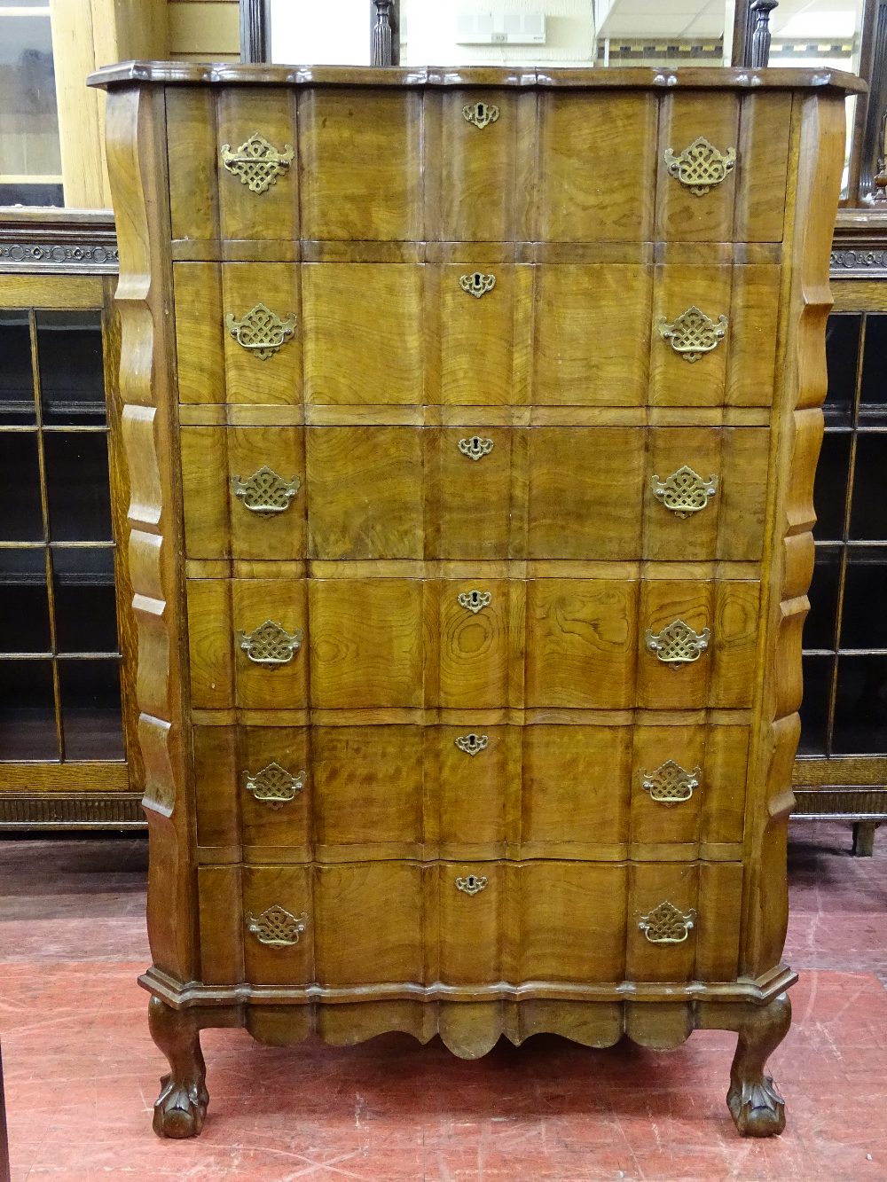 A GOOD REPRODUCTION WALNUT SIX DRAWER CHEST with shaped top and drawers, pierced brasswork, on