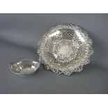 A CIRCULAR SILVER PIERCED BOWL with scroll & leaf border and with pierced & floral base & edging,