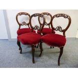 A CLEAN SET OF FOUR VICTORIAN CARVED WALNUT SALON CHAIRS with stuffover upholstered seats