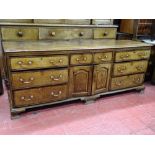 A GEORGE III OAK & CROSSBANDED MAHOGANY LANCASHIRE DRESSER BASE, having a central two drawer and two