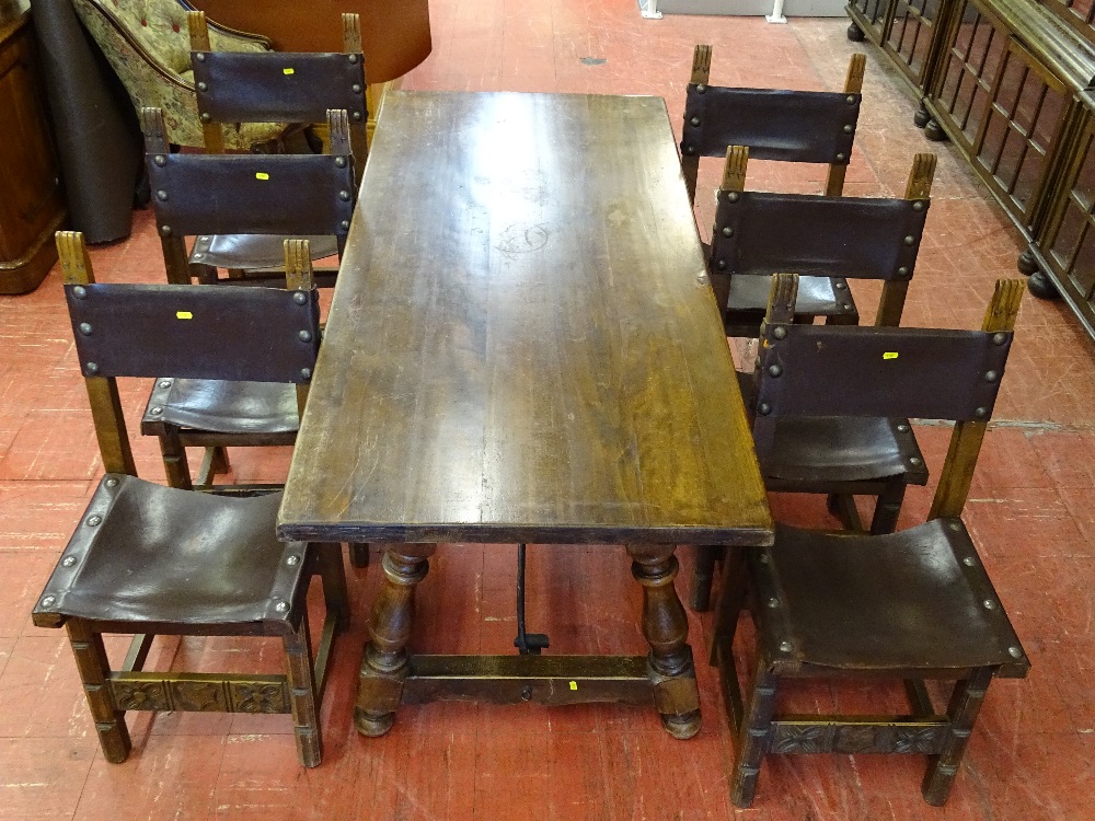 A REPRODUCTION REFECTORY STYLE DINING TABLE & six leather seat and backed chairs having large