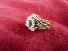 A FOURTEEN CARAT GOLD DRESS RING with central 0.5 carat diamond (from J C Penny), 7.5 grms, size '