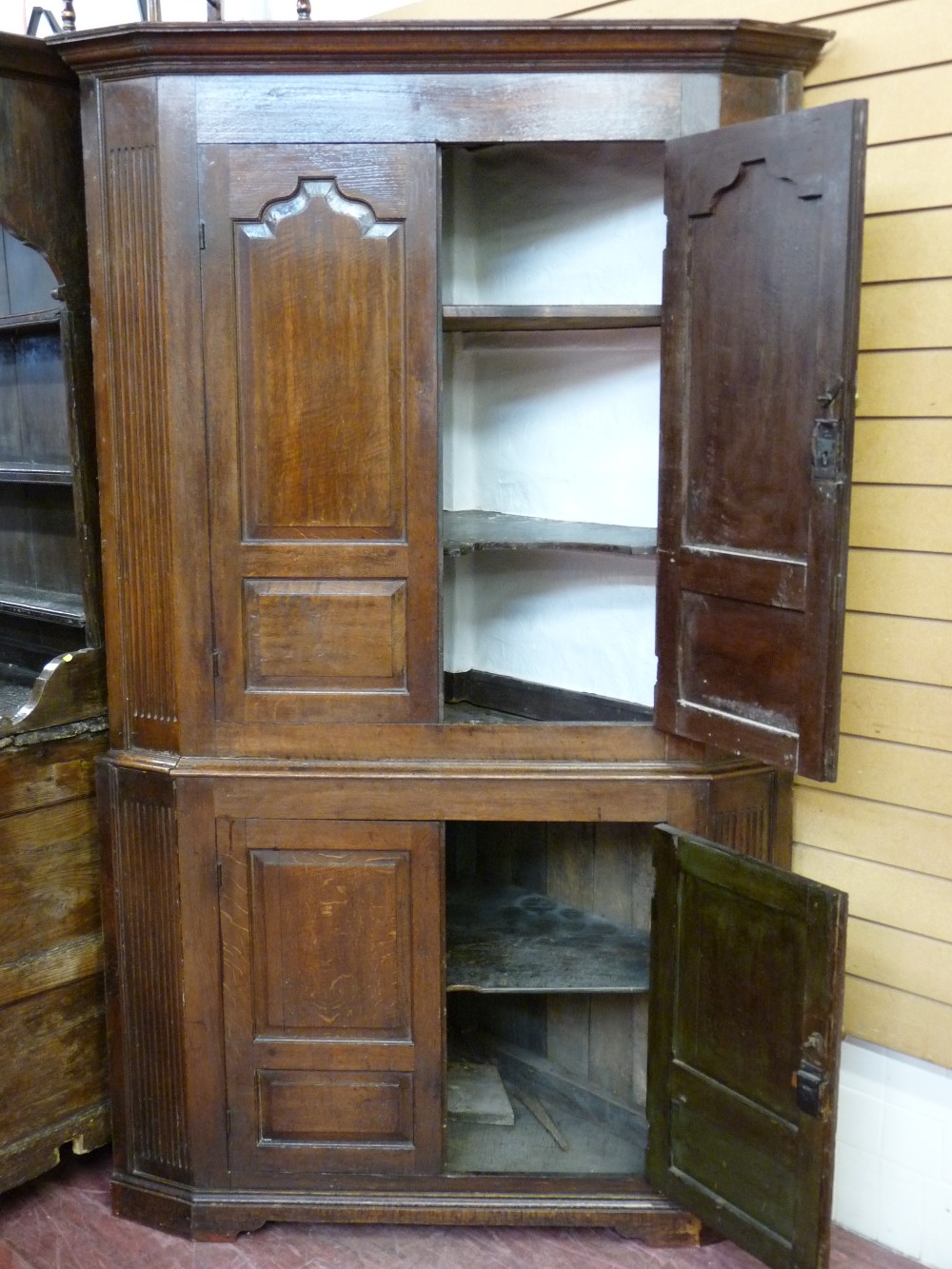 AN ANTIQUE OAK TWO PIECE STANDING CORNER CUPBOARD, twin upper and lower doors having shaped and - Image 2 of 2