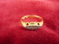 A LADY'S EIGHTEEN CARAT GOLD DRESS RING with five tiny diamonds, 2.4 grms, size O