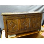 AN ANTIQUE OAK BLANKET CHEST of pegjoined construction having triple panel lift-up lid and front,