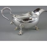 A SILVER SAUCE BOAT with scroll handle on three shell feet, London 1970, 12.4 troy ozs, 21.5 cms