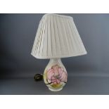 A MOORCROFT 'MAGNOLIA' TABLE LAMP decorated on a cream ground, impressed factory marks, with pleated