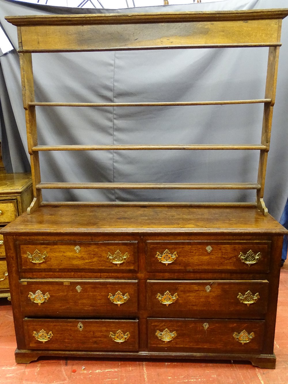 AN ANTIQUE CONVERTED MULE CHEST/DRESSER, the base having six opening drawers with pierced brass