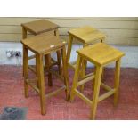 A SET OF FOUR VINTAGE LABORATORY STOOLS, two 68 cms high, two 62 cms high