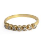 A brilliant cut diamonds half eternity ring with an 18 ct. yellow gold setting