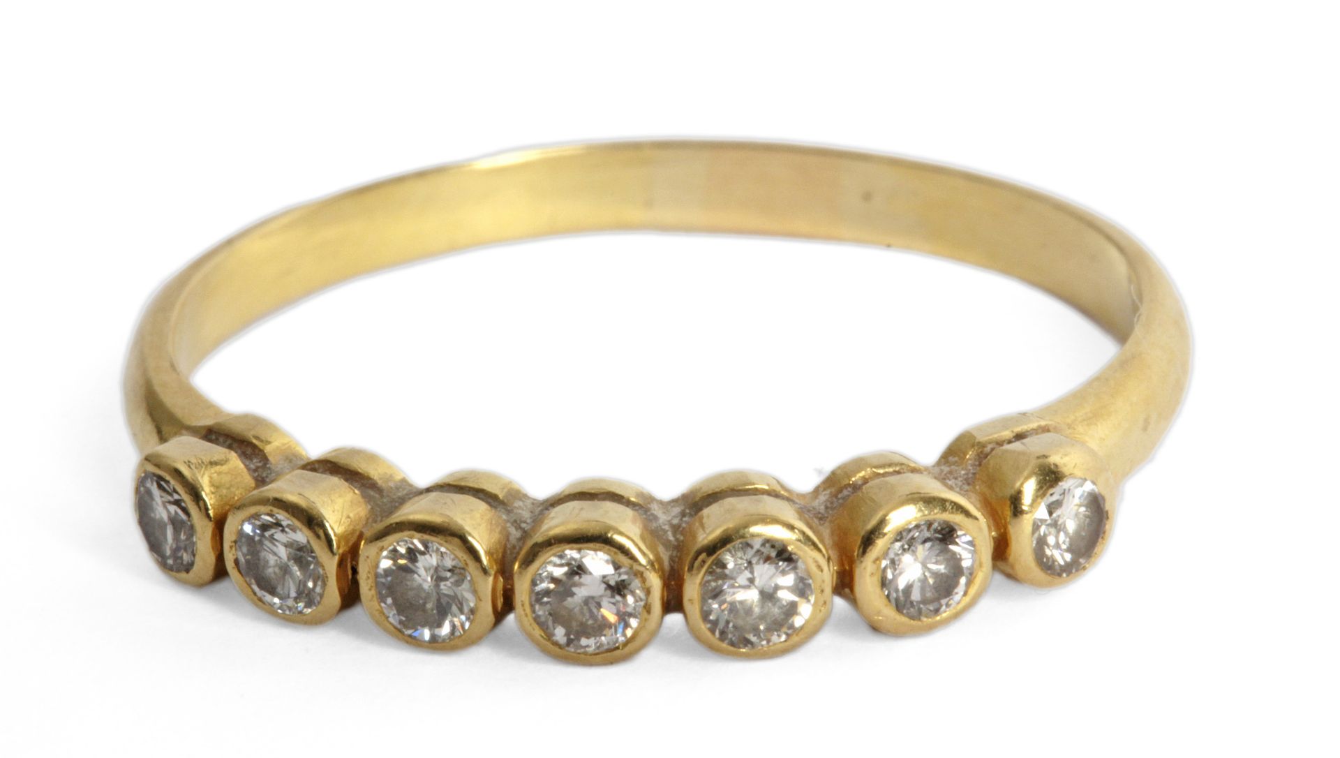 A brilliant cut diamonds half eternity ring with an 18 ct. yellow gold setting