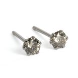 A pair of stud earrings with brilliant cut diamonds in a platinum setting with an 18ct. white gold