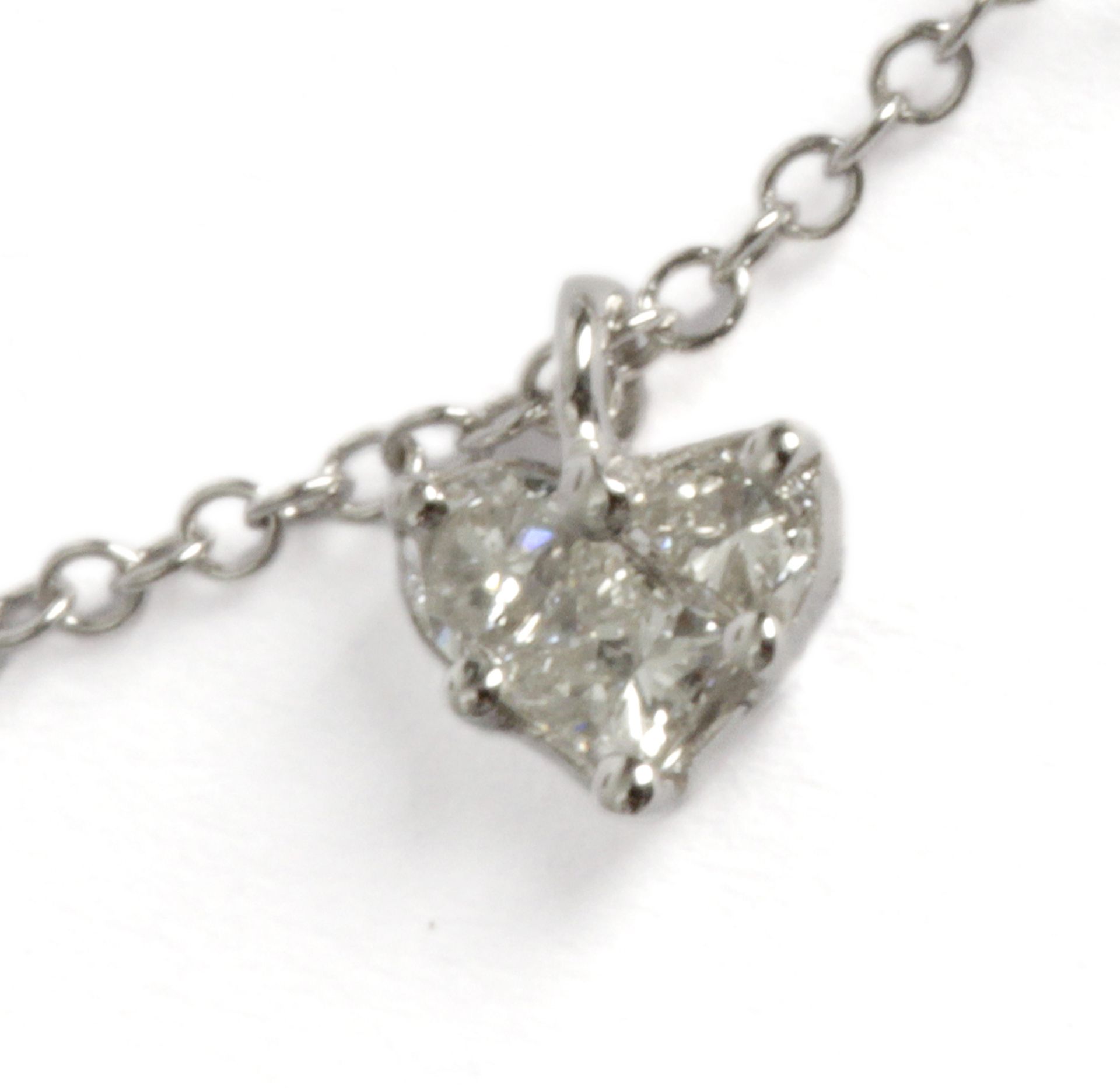 A heart shaped pendant. 18 ct. white gold with triangle cut and princess cut diamonds. With an 18 c