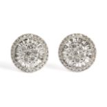 A pair of cluster earrings. 18ct. white gold with brilliant cut and baguette cut diamonds