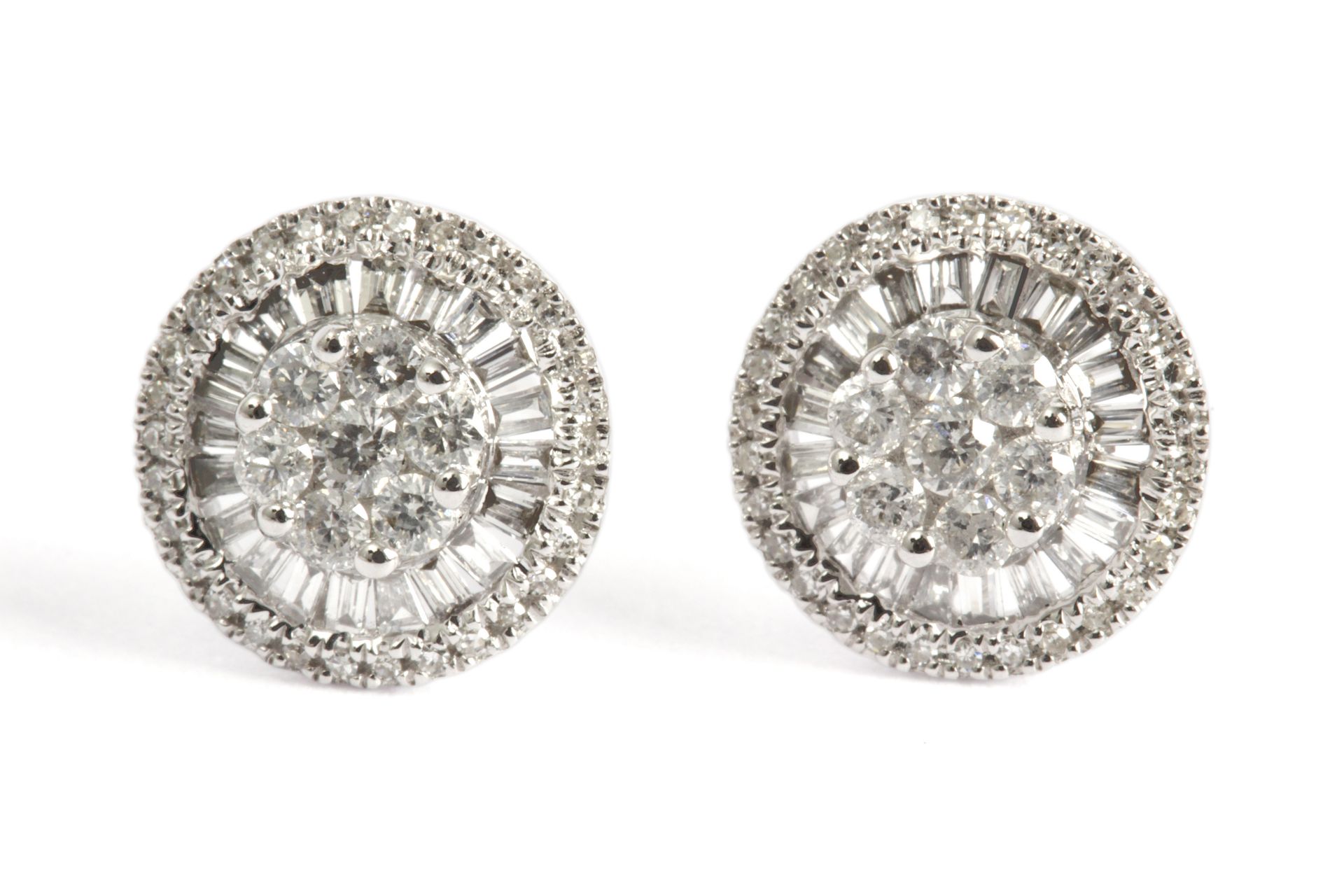 A pair of cluster earrings. 18ct. white gold with brilliant cut and baguette cut diamonds