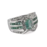 An emerald ring. 18ct. white gold, central stone: 0,50 ct. emerald cut emerald with carre cut emera