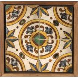 An 18th century wallplaque with four Catalan showing tiles