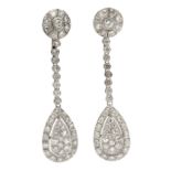 A pair of long earrings. Platinum and brilliant cut diamonds