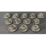 A 20th century French set of twelve tea cups and saucers in Limoges porcelain