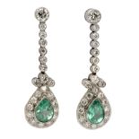 A pair of diamond and emerald long earrings. Platinum, 2,5 ct. of brilliant cut diamonds and 2 ct.